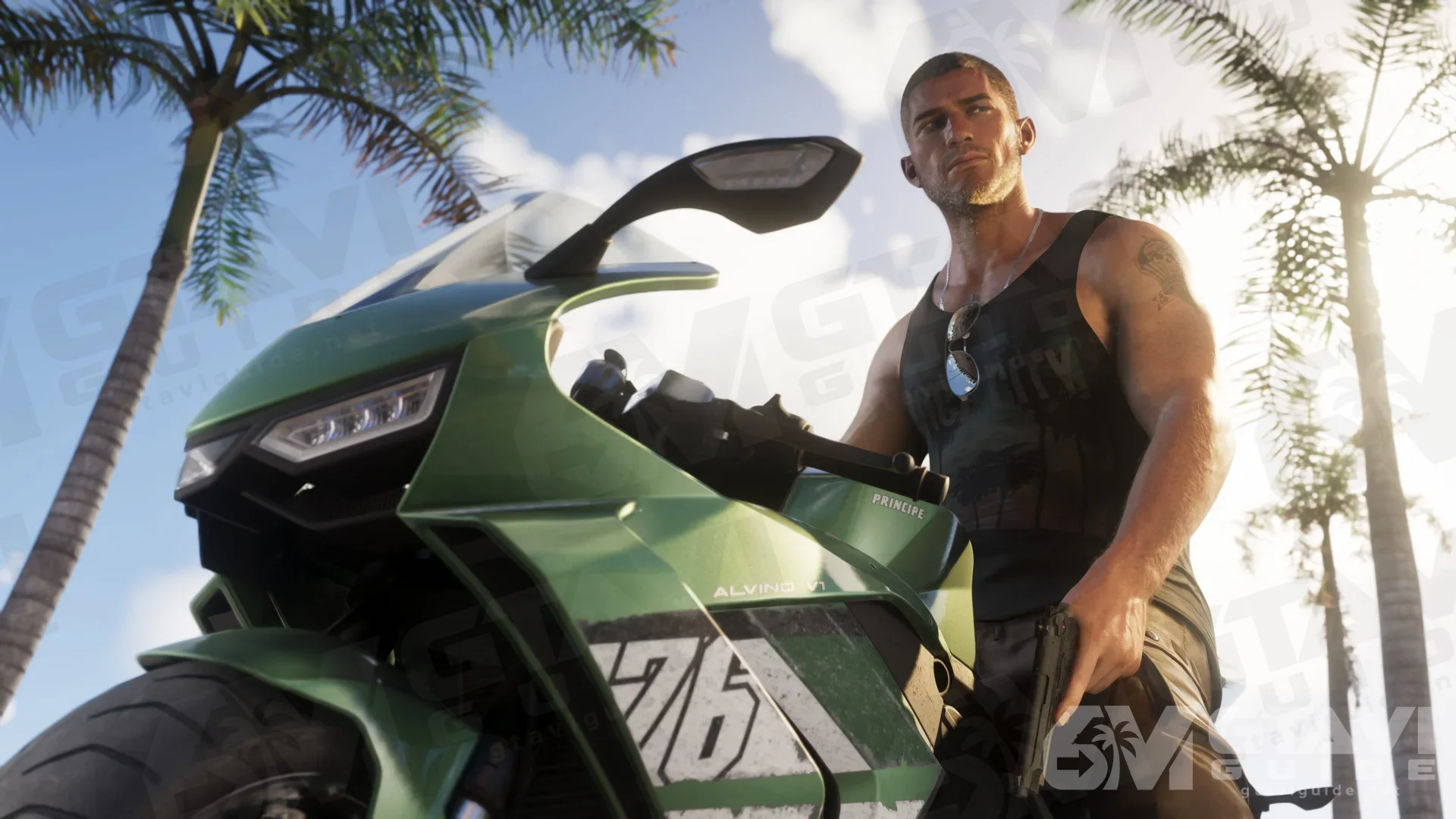 Jason beside a green motorcycle, with palm trees behind him.
