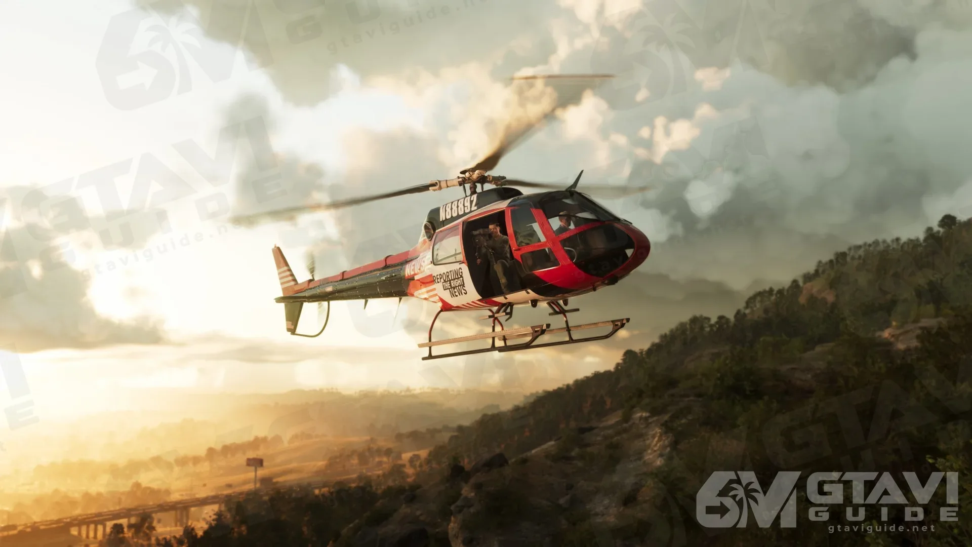 A red and white helicopter flying low over wooded hills