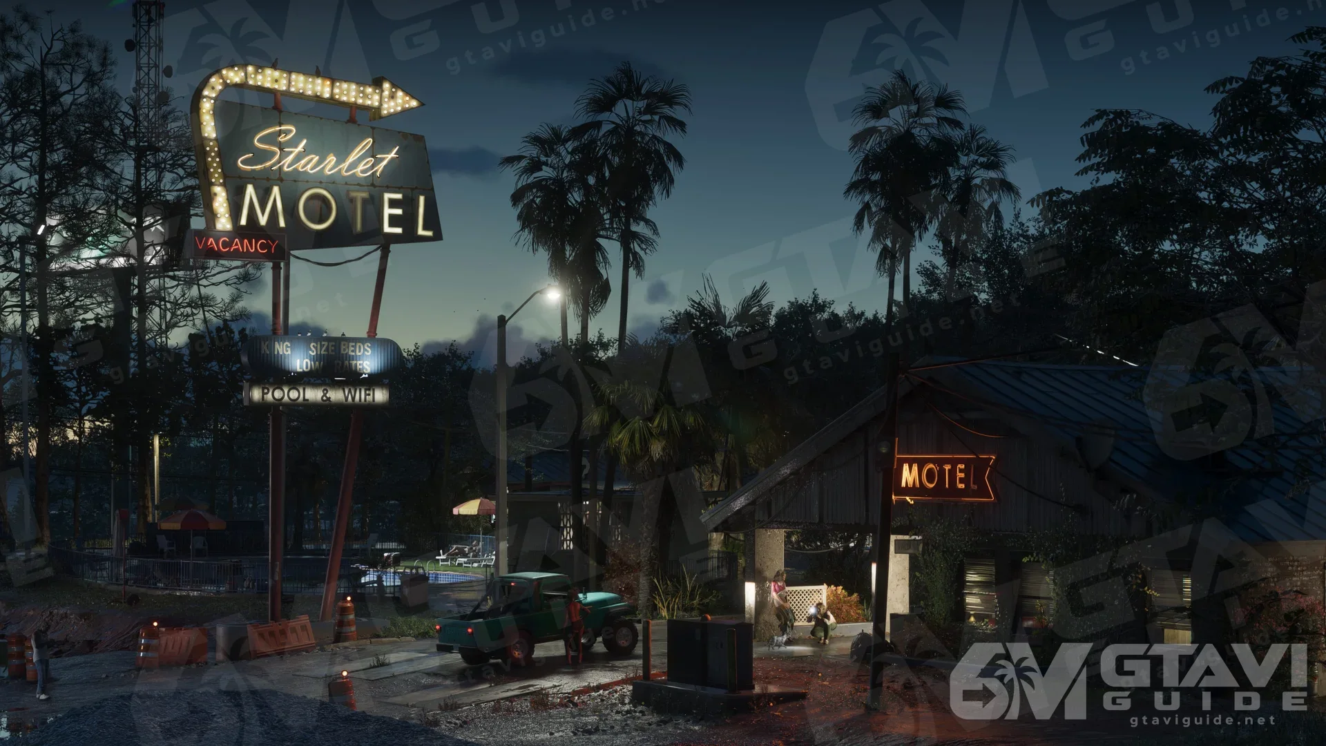 The Starlet Motel building and illuminated sign at night.