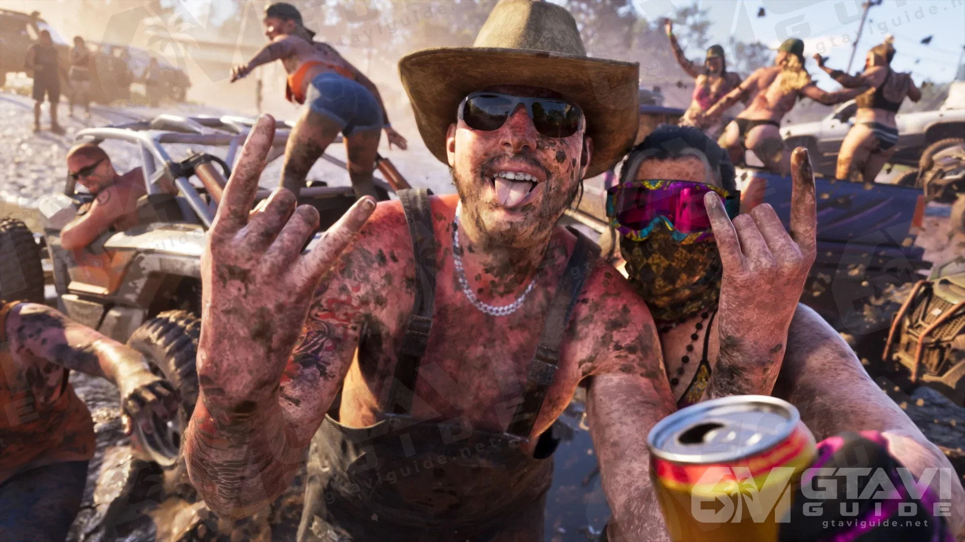 A mud-covered man in a cowboy hat with a partying crowd and off-road vehicles behind him